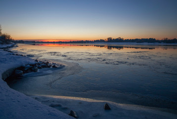 the river bank Volga covered with ice against the background of setting the sun
