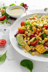 Sweet Corn salad with tomatoes, avocado, red onion, herbs and lime