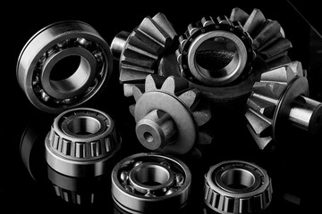 Gears, bearings and differential stars lie on the table close-up