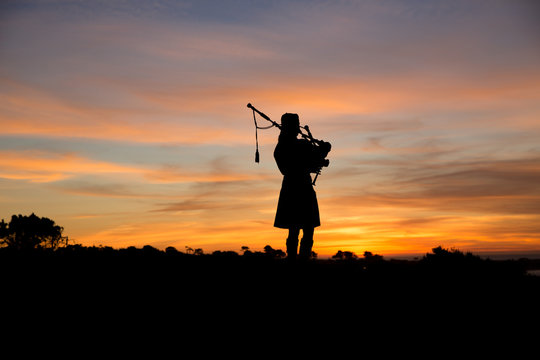 Bagpiper at sunset by the ocean