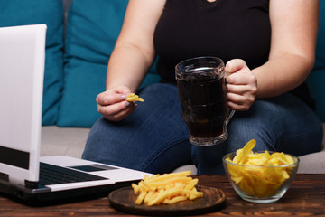 mindless snacking, overeating, lack of physical activity, laziness, homebody. fat overweight woman...