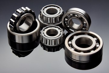 Close-up of a set of ball and roller bearings on a dark background