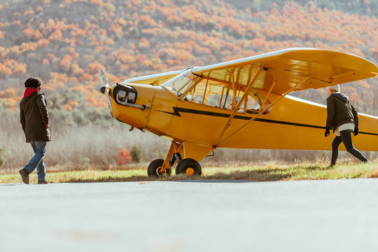 Friends ready a prop plane for flight