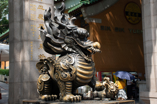 Sculpture stone Qilin dragon guardian at entrance of Wong Tai Sin Temple at Kowloon in Hong Kong, China
