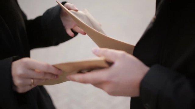 Clouse-up male spy sends secret documents to the woman, instead of receiving the envelope with money. Industrial espionage. The work of foreign agents.