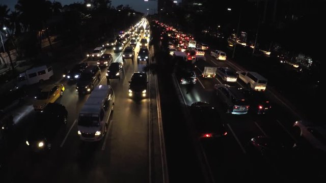Roxas Blvd., Manila, Philippines - September 23, 2016: Rush hour night traffic of vehicles passing six lane road. aerial