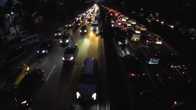 Roxas Blvd., Manila, Philippines - September 23, 2016: Rush hour night traffic of vehicles passing six lane road. aerial