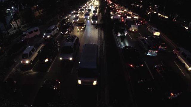 Roxas Blvd., Manila, Philippines - September 23, 2016: Rush hour night traffic of vehicles passing six lane road. aerial