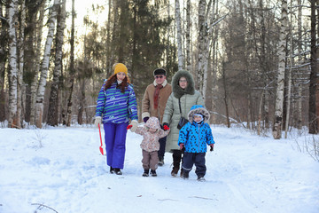 Family with kids in winter park on weekend