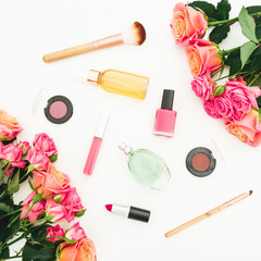 Beauty feminine composition with roses flowers and makeup cosmetics on white background. Flat lay, top view. Spring background