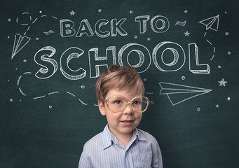 Adorable little boy with blackboard and back to school concept