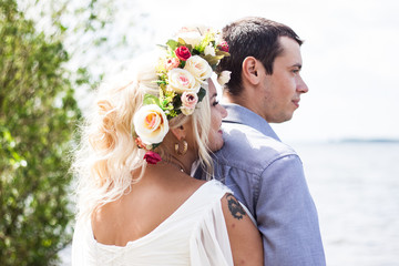 photo session of a girl in a wreath and her boyfriend love story in nature
