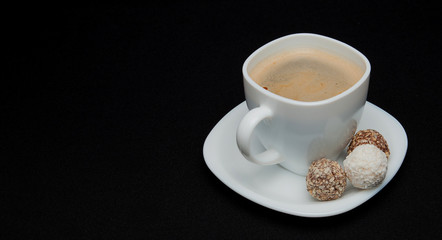 Coffee cup, beans, chocolate and macaroons on old kitchen table. Top view with copyspace for your text