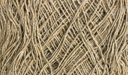 Linen rough threads, old shabby rustic background texture, raw material for industrial or agrarian needs