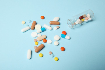 Pills and drug addiction. Medical colorful capsules.