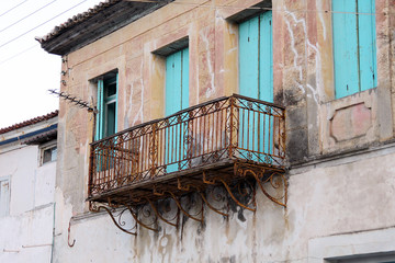 Fototapeta na wymiar Metal openwork balcony in the old house