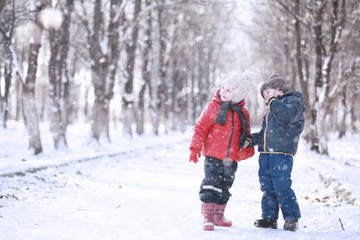 Kids walk in the park first snow