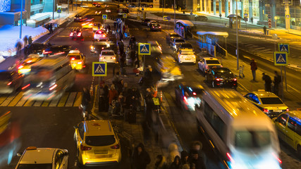 Crowds of people and the flow of taxis at the exit of the airport,