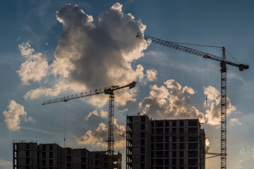 Cranes working day and night on construction of the housing estate in former industrial zone