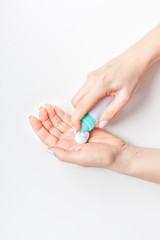 Woman moisturizing her hands with foam lotion