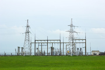 Transformer substation high voltage electrical network in the meadow on beautiful flat land scenic...