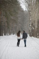 pair of lovers on a date winter afternoon in a snow blizzard