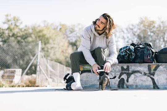 Portrait of men preparing to training with roller skates.