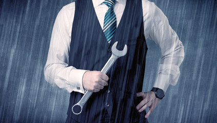 Young handsome  man holding tool with raindrop graphic