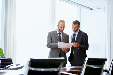 Businessmen Discussing Over Document In Office