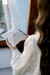 Girl with a pillow on her hand and a wedding ring on the pillow