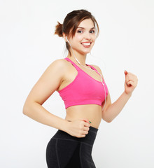 portrait of a smiling fitness woman in headphones working out isolated over white background