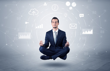 Elegant calm businessman levitates in yoga position with data circulation concept
