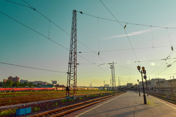 Jule 1, 2018. Krasnoyarsk. Russia. view of the railway station of the sunset. Electric support with wires