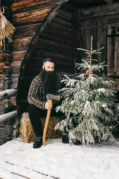 Bearded Male Hipster in Norwegian Knitwear Sitting in Front of T