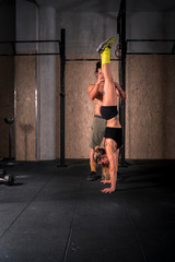 Couple learning to stand upright on their hands.