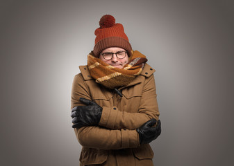 Fototapeta na wymiar Handsome young boy freezing in warm clothing with copy space