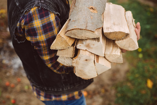 man carries wood pieces