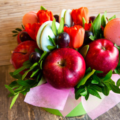 gift composition of flowers, fruits and sweets