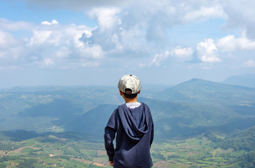 Asian boys see the mountains and the sky at Phu Rua National Park in Loei, Thailand.