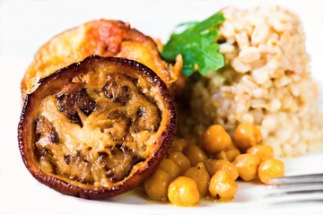 Aubergine, chickpeas and barley pearl on white, closeup.