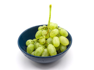 Bunch of green grapes in a plate isolated on white background