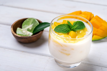 Fresh mango juice and mango fruit on white background