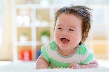 Happy baby boy lying down and resting