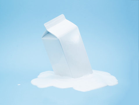 White milk carton melting on blue background