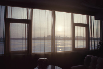 The view from the window with curtains on the river.