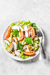 Chicken,garbanzo beans, tomato salad. Top view, space for text.
