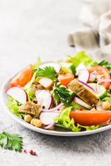 Grilled chicken tomato chickpeas salad with olive oil mustard vinaigrette. Selective focus, space for text.