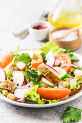 Grilled chicken tomato chickpeas salad with olive oil mustard vinaigrette. Selective focus, space for text.