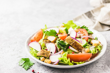 Grilled chicken tomato chickpeas salad with olive oil mustard vinaigrette. Selective focus, space for text.