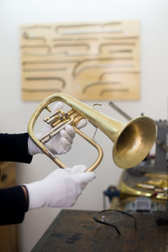 Man fixing trumps in his repair workshop
